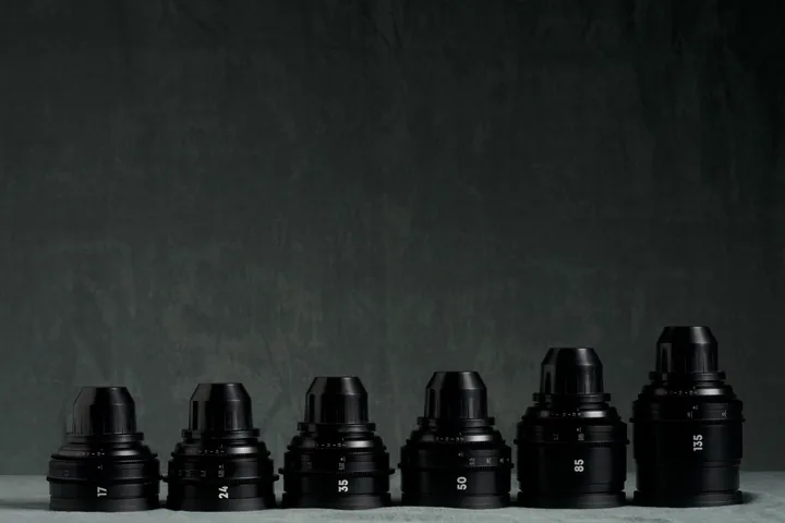 Set of rehoused Canon FD prime lenses lined up on the studio cloth.