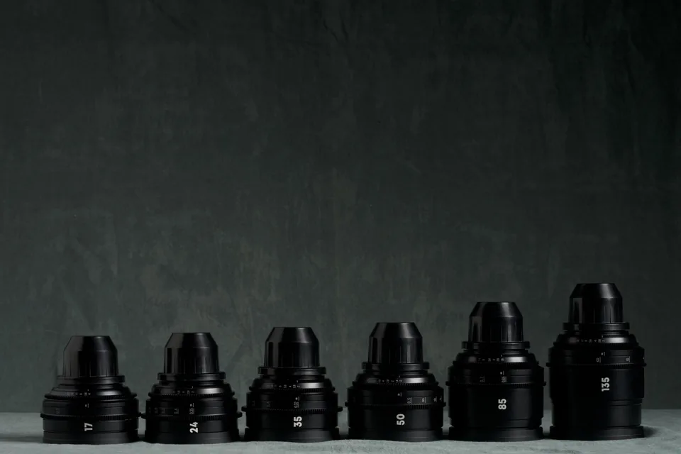 Set of rehoused Canon FD prime lenses lined up on the studio cloth.