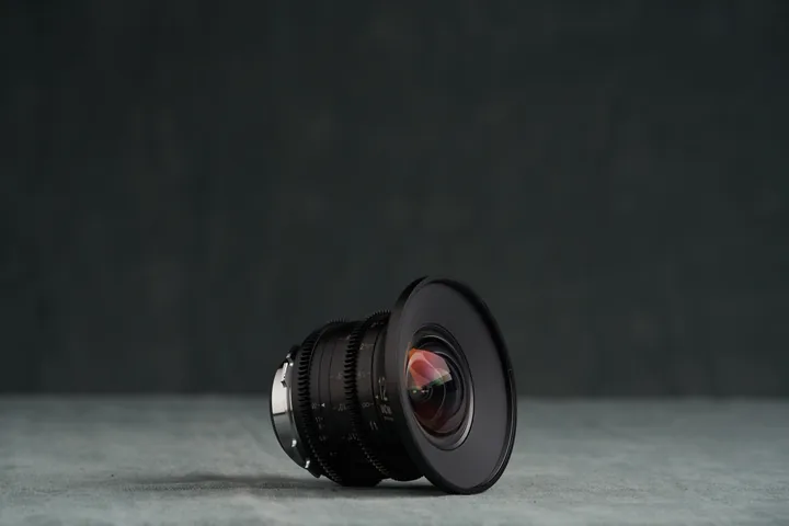 Laowa 12mm rectilinear wide lens standing alone against the studio backdrop.