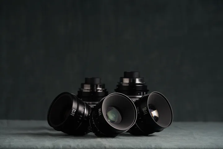 Laowa Nanomorph prime lenses grouped on the studio cloth.