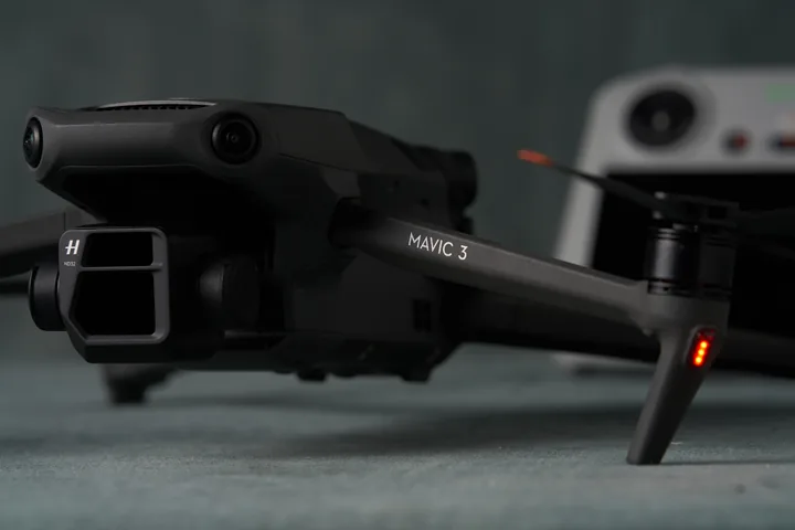 DJI Mavic 3 Pro drone folded on the studio table with its controller behind.