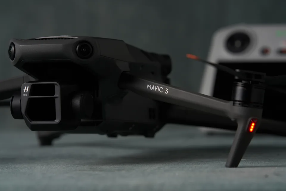 DJI Mavic 3 Pro drone folded on the studio table with its controller behind.